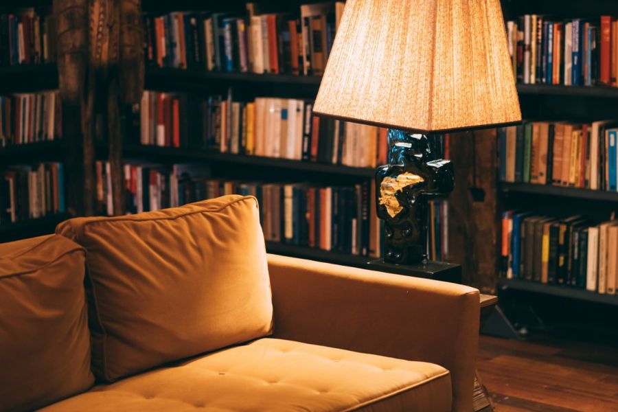 Retro couch and lamp in a library